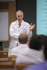 Photo of doctor robert solomon presenting a case